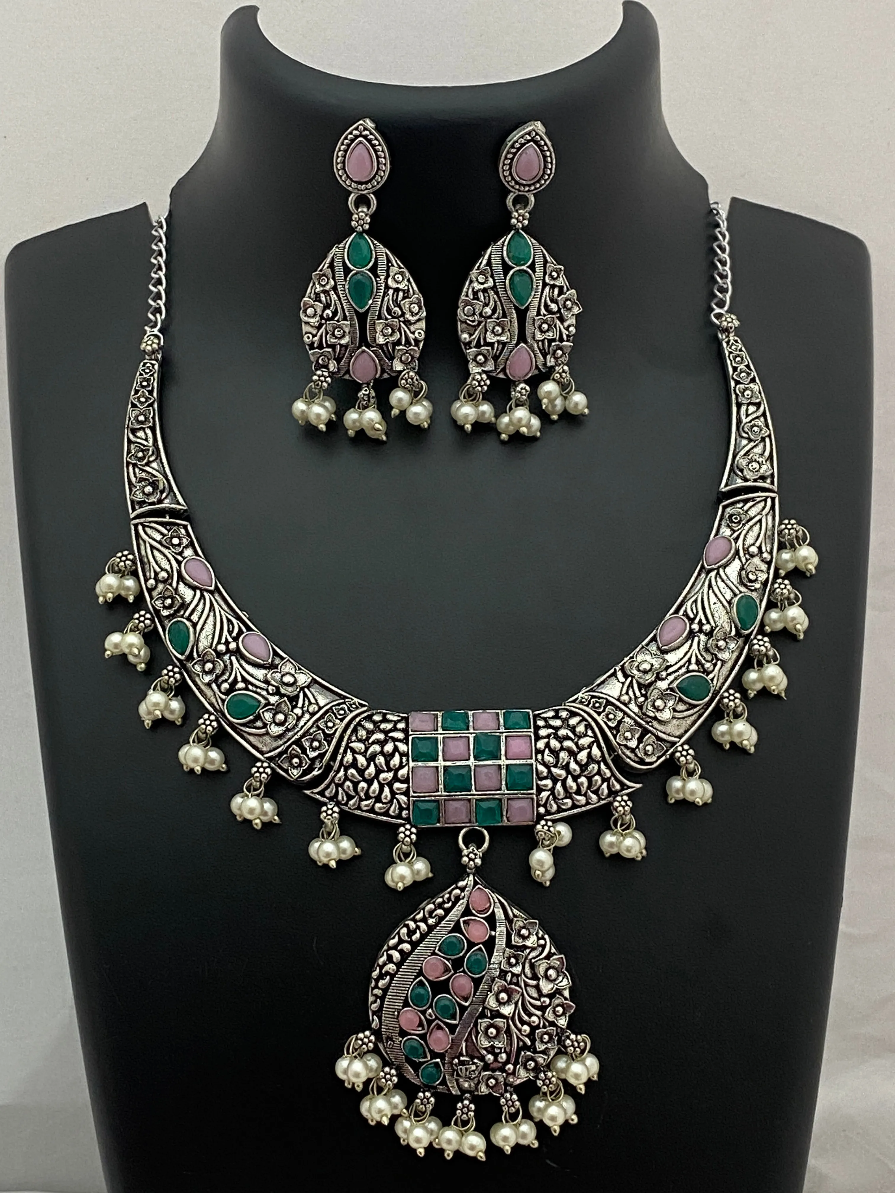 Charming Oxidized Floral Choker Necklace Set With Emerald And Pink Stone