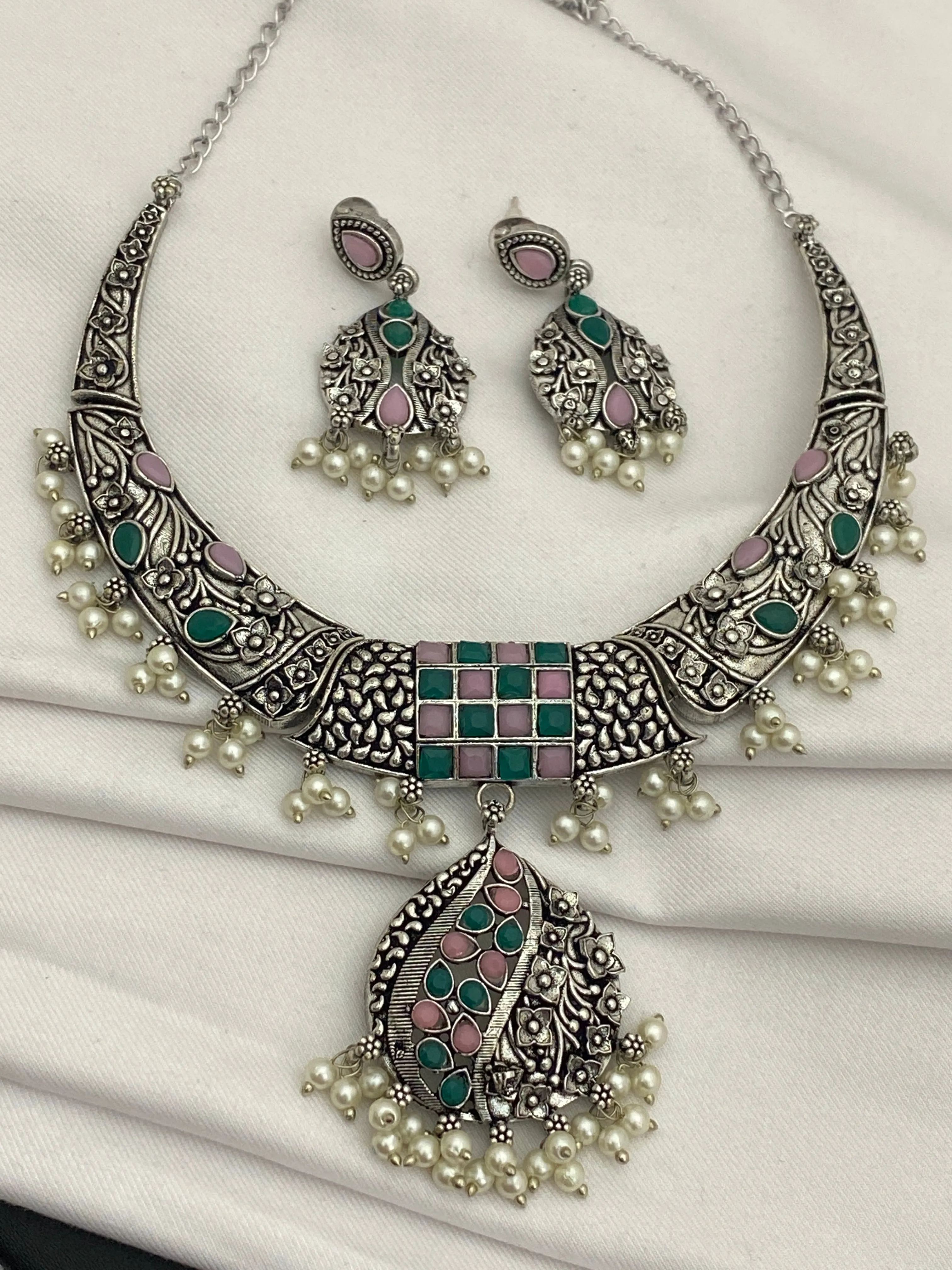 Charming Oxidized Floral Choker Necklace Set With Emerald And Pink Stone